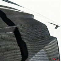 Close-up of VASL carbon fiber front hood on Chevrolet Corvette C8, highlighting weave pattern, surface texture, and craftsmanship