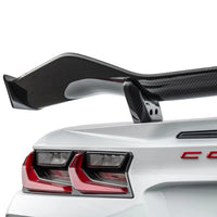 Detailed close-up of VASL carbon fiber rear spoiler on Corvette C8 Z06, showing 3D weave texture and mounting points