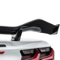 Detailed close-up of VASL carbon fiber rear spoiler on Corvette C8 Z06, showing 3D weave texture and mounting points