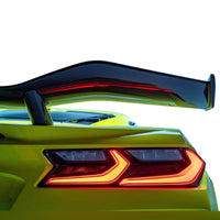 Detailed close-up of VASL carbon fiber rear spoiler on Corvette C8 Z06, showing 3D weave texture and mounting points