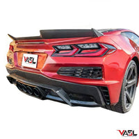 Close-up of VASL carbon fiber rear spoiler installed on a Corvette C8 Z06, showing precise fitment, carbon fiber weave, and aerodynamic curvature