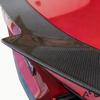 Close-up of VASL carbon fiber rear spoiler installed on a Corvette C8 Z06, showing precise fitment, carbon fiber weave, and aerodynamic curvature